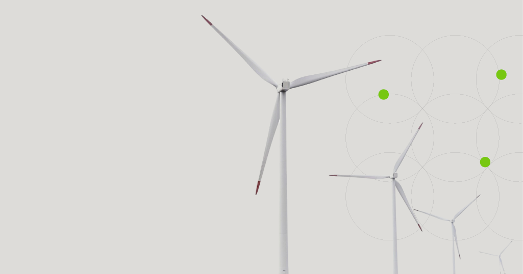 Wind turbines above green grass, representing renewable operations with a clean white background and circular graphic accents.